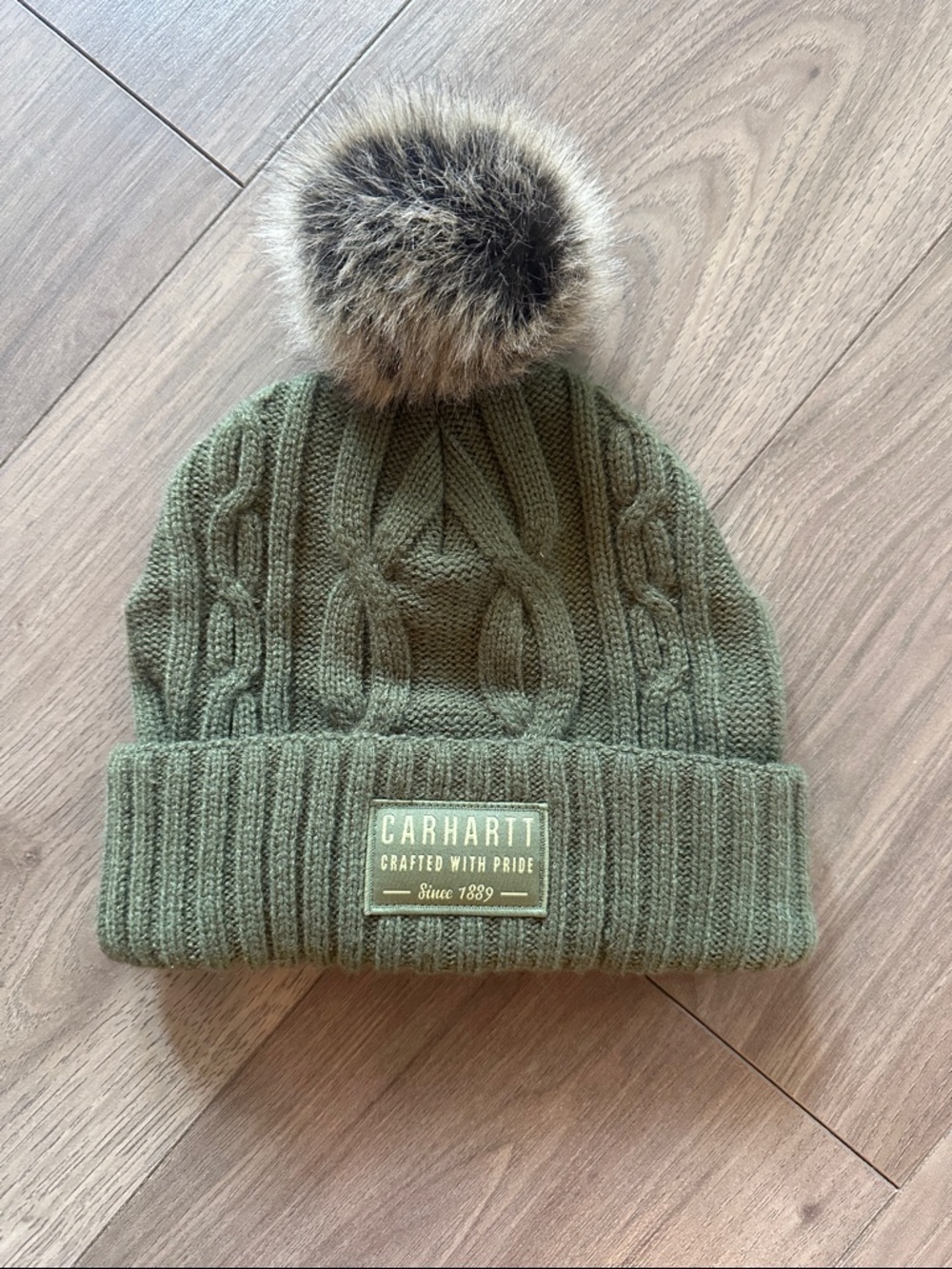 Carhartt beanie hat with faux fur Pom Pom . Like new!